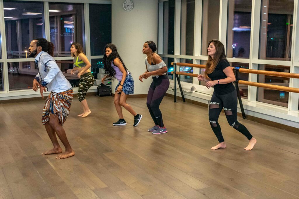 Energetic dance class with diverse adults embracing active lifestyle indoors.